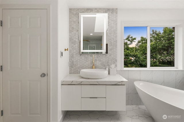 bathroom with a bath and vanity