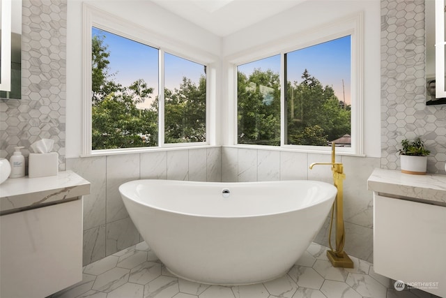 bathroom featuring tile walls and a tub