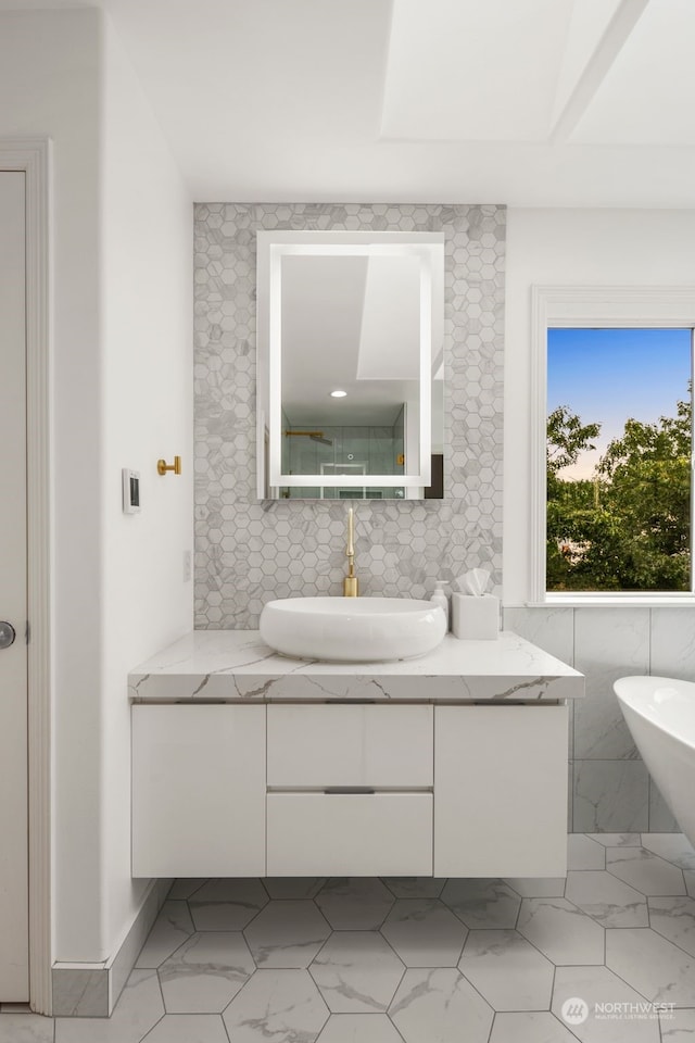 bathroom with vanity and tile walls