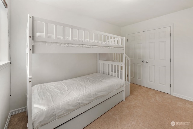 carpeted bedroom featuring a closet