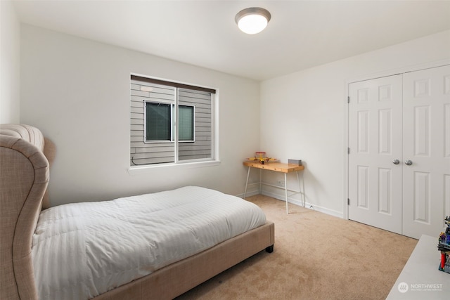 bedroom with light carpet and a closet