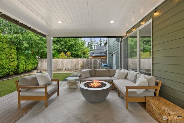 view of patio with an outdoor living space with a fire pit