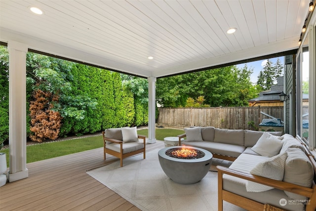 deck with an outdoor living space with a fire pit