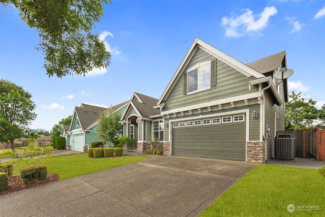 craftsman inspired home featuring central AC unit, a garage, and a front yard