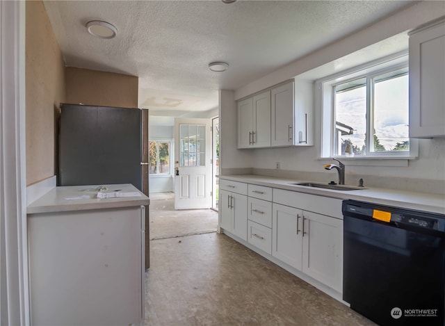 kitchen featuring white cabinets, a textured ceiling, sink, and black appliances