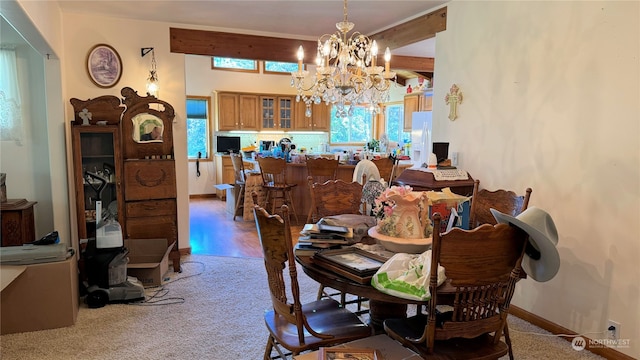 carpeted dining space with an inviting chandelier and beam ceiling