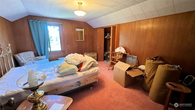 carpeted bedroom featuring lofted ceiling and wood walls