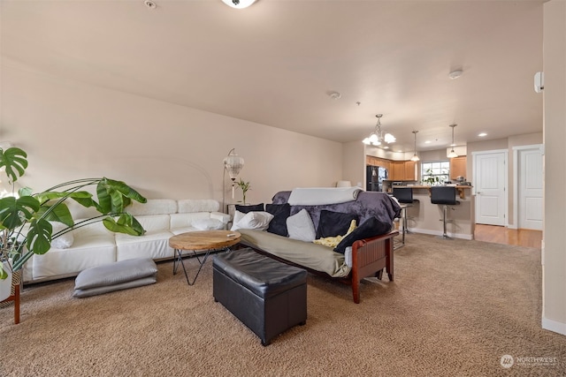 living room featuring carpet floors and a chandelier