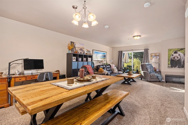 dining space featuring an inviting chandelier and carpet flooring