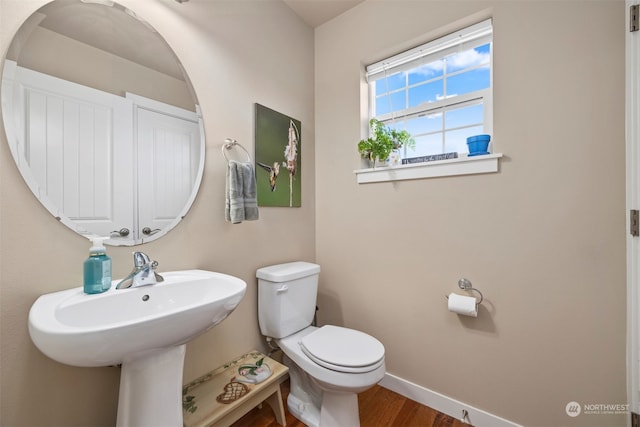 bathroom with hardwood / wood-style floors and toilet