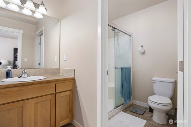 bathroom featuring walk in shower, vanity, toilet, and tile patterned floors