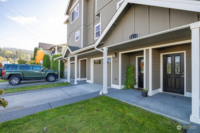 exterior space with a garage and a lawn