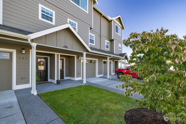 exterior space featuring a lawn and a garage