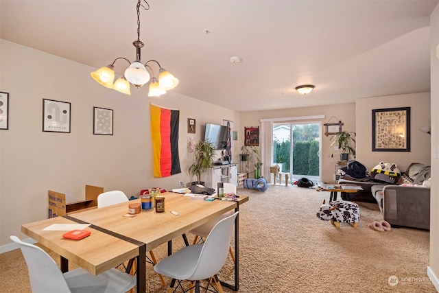 carpeted dining area featuring a chandelier