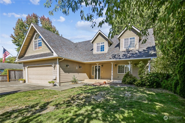 cape cod house with a garage and a front yard