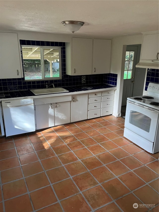 1721 Division St NW, Olympia, WA 98502 - kitchen featuring white appliances, tile countertops, a sink, tasteful backsplash, and white cabinets