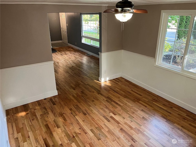 1721 Division St NW, Olympia, WA 98502 - spare room with crown molding, wood finished floors, baseboards, and a ceiling fan