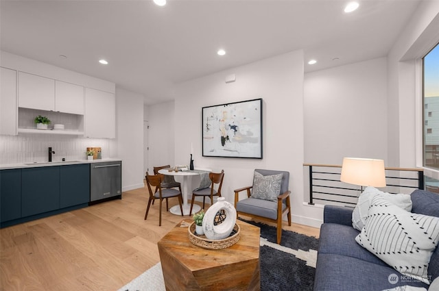 living room with sink and light hardwood / wood-style floors