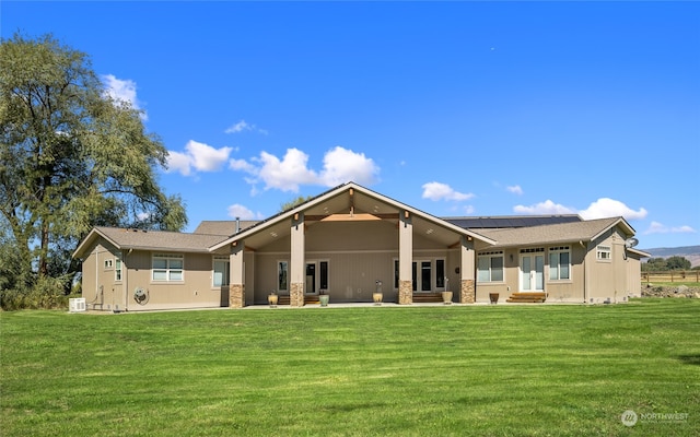 rear view of house with a lawn