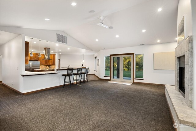 living room with carpet, lofted ceiling, and ceiling fan