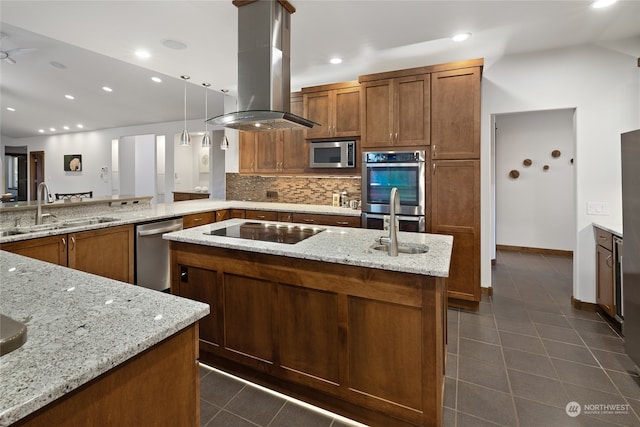 kitchen featuring pendant lighting, sink, vaulted ceiling, island range hood, and appliances with stainless steel finishes