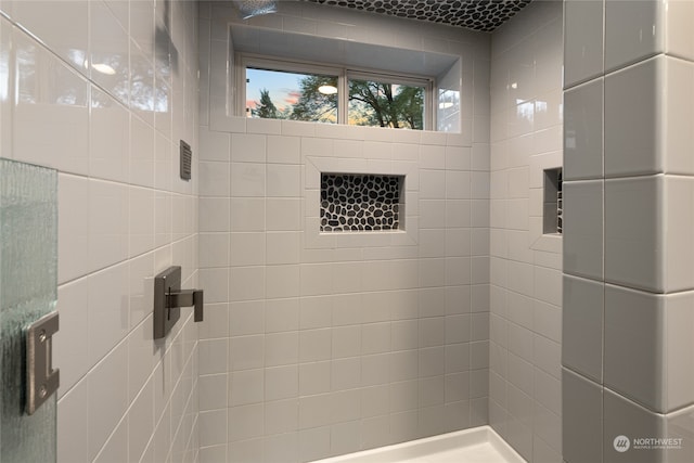 bathroom with a tile shower