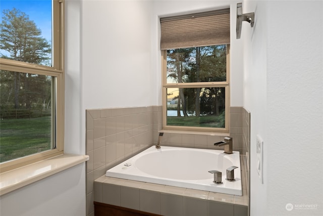 bathroom with a relaxing tiled tub