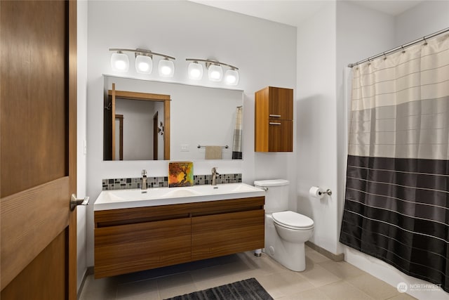 bathroom featuring vanity, tile patterned flooring, and toilet