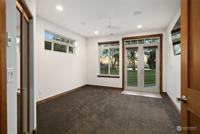 carpeted empty room with ceiling fan and french doors