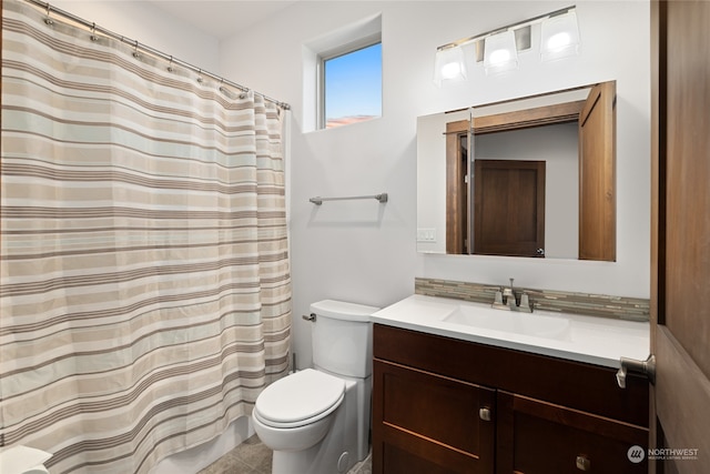 bathroom featuring curtained shower, vanity, toilet, and tile patterned floors