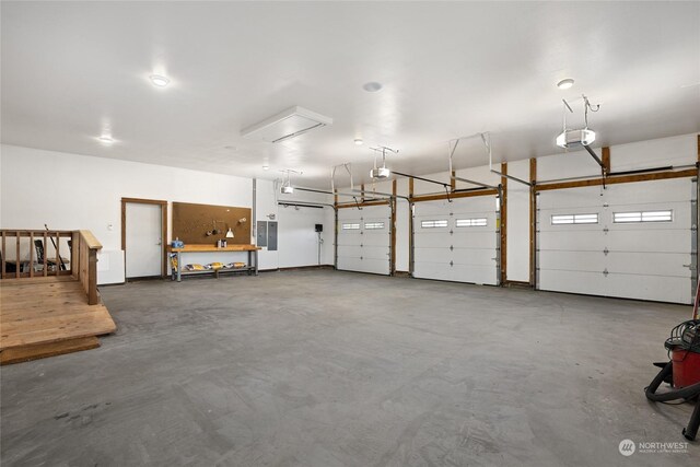 garage featuring electric panel and a garage door opener