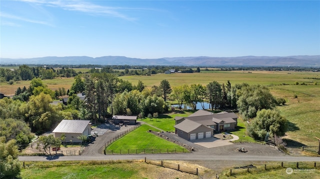 drone / aerial view with a water and mountain view and a rural view