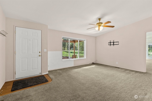 carpeted empty room featuring ceiling fan