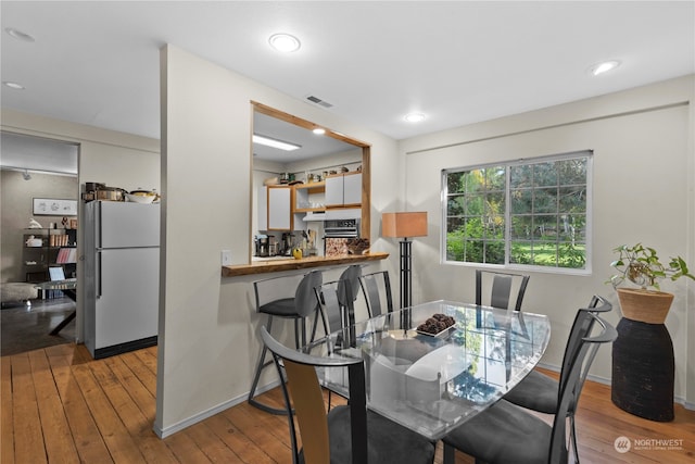 dining room with light hardwood / wood-style flooring