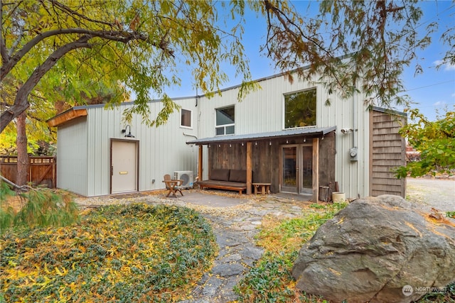 rear view of house featuring ac unit and french doors