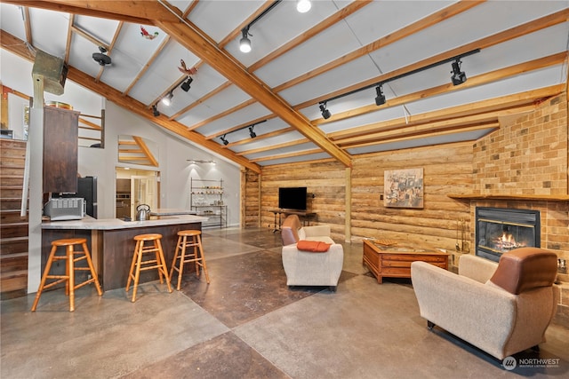 living room featuring a fireplace, concrete floors, and lofted ceiling with beams