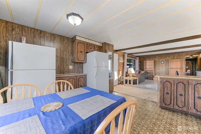 dining room with wood walls