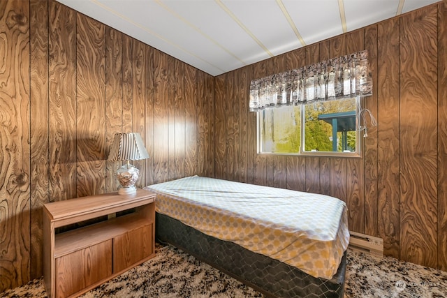 bedroom with wooden walls and baseboard heating