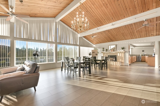 tiled dining area with wooden ceiling, ceiling fan with notable chandelier, beamed ceiling, and high vaulted ceiling