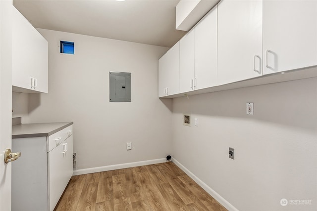 clothes washing area featuring hookup for an electric dryer, electric panel, cabinets, light hardwood / wood-style flooring, and hookup for a washing machine