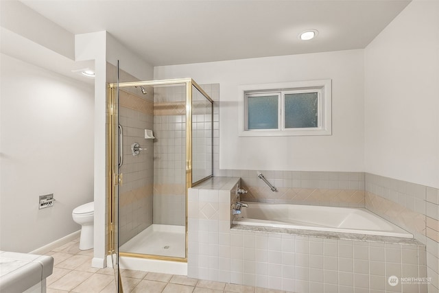 bathroom with toilet, tile patterned floors, and separate shower and tub