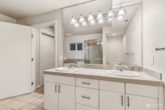 bathroom with toilet, an enclosed shower, vanity, and tile patterned floors