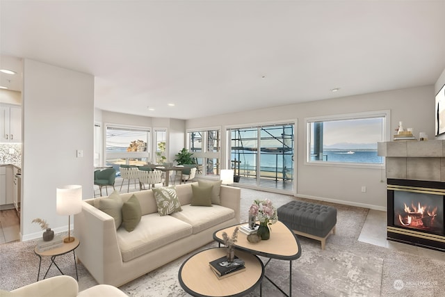 living room featuring a fireplace and a water view