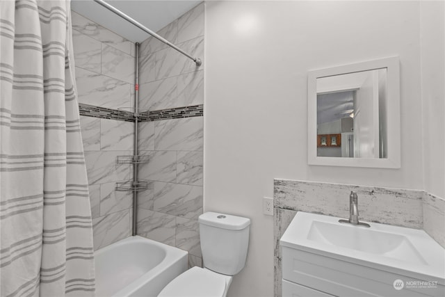 full bathroom featuring shower / bathtub combination with curtain, vanity, and toilet