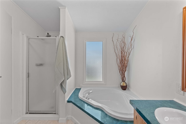 bathroom with tile patterned floors, independent shower and bath, and vanity