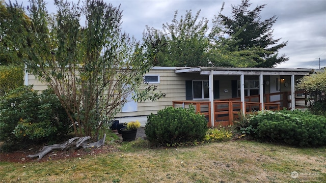 back of house with a wooden deck