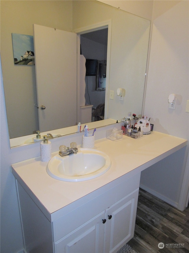 bathroom with hardwood / wood-style floors and vanity