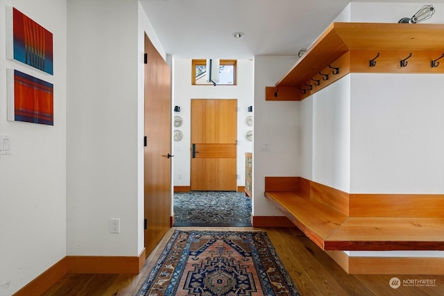 mudroom with baseboards and wood finished floors