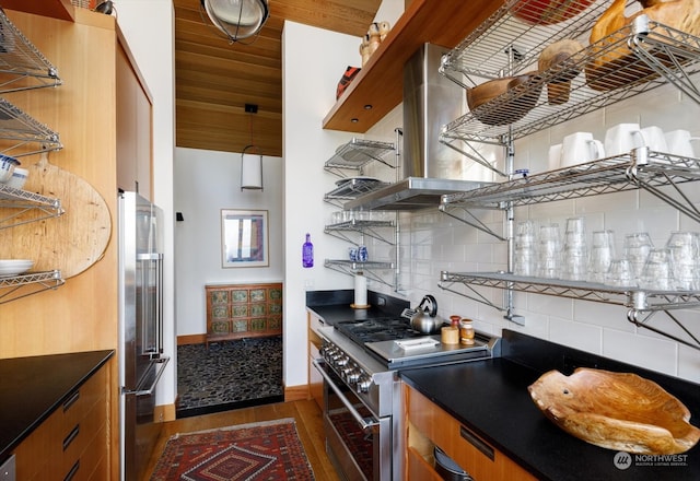 kitchen featuring dark wood-style floors, open shelves, dark countertops, high quality appliances, and backsplash