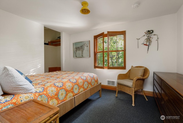 carpeted bedroom with visible vents and baseboards